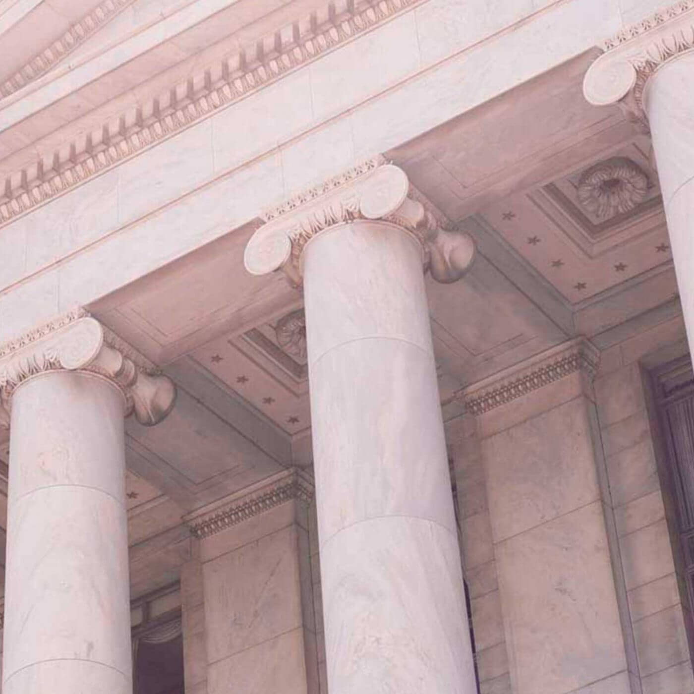 A closeup of columns on an ornate building.