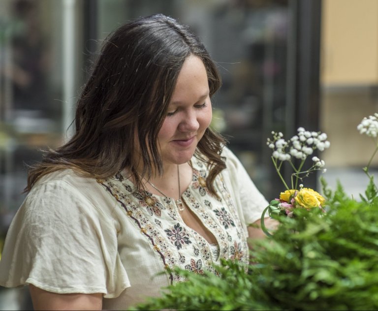A woman looking at pretty flowers